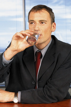 Businessman drinking waterの写真素材