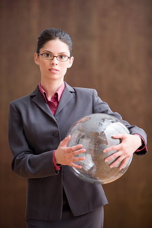 Businesswoman holding inflatable globeの写真素材