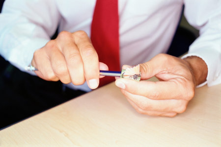 Man sharpens pencil