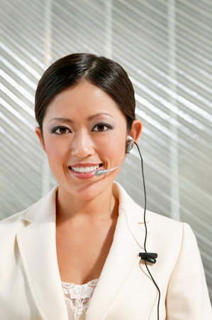 Woman wearing telephone headsetの写真素材