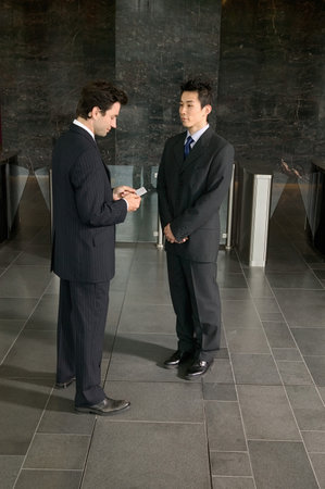 Businessmen exchanging business cardsの写真素材