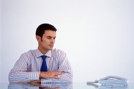 Businessman looking at phoneの写真素材