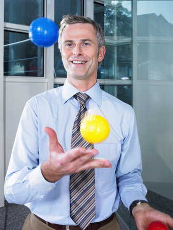 Businessman juggling