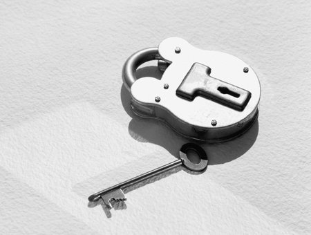 A metal padlock and its key