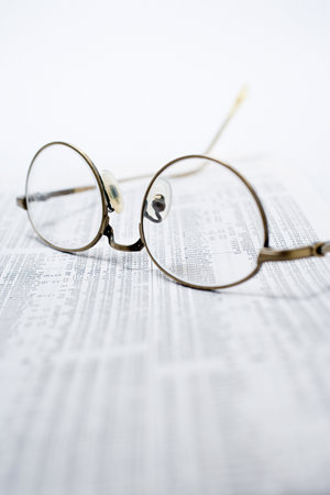 Glasses on financial pagesの写真素材