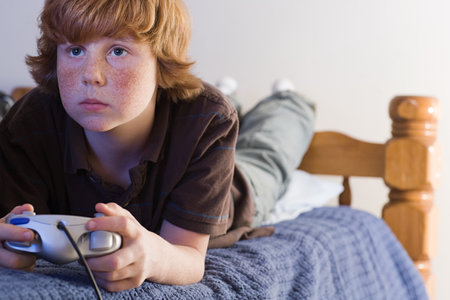 A boy playing a video gameの写真素材