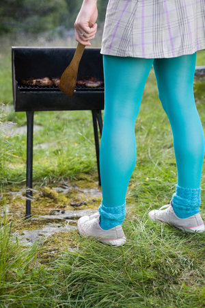 Woman barbecuing foodの写真素材