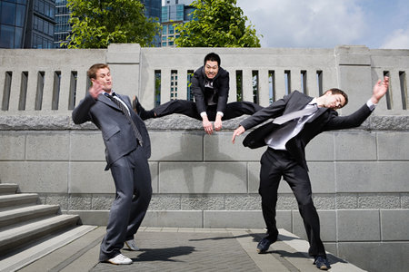 Businessman kicking rivals