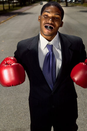 Businessman wearing boxing glovesの写真素材