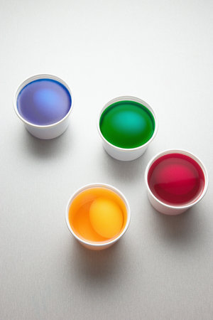 Eggs in cups of paint