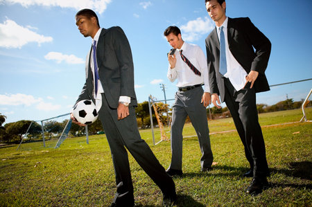 Businessmen on football pitchの写真素材