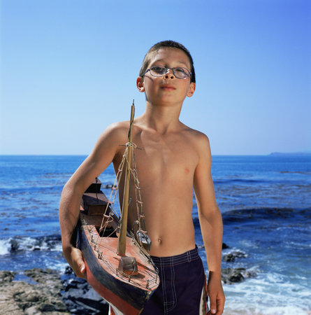 Boy holding model boatの写真素材