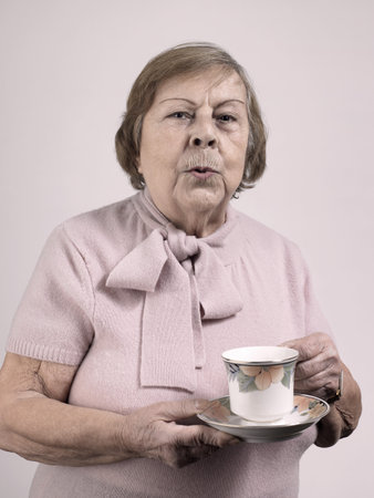 Woman with a teacup and saucerの写真素材