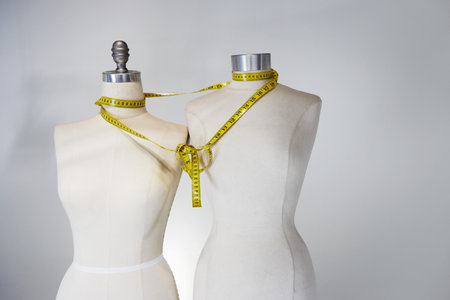 Tape measure tied around tailors dummiesの写真素材