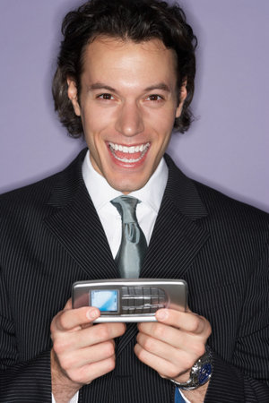 Excited businessman with cellphoneの写真素材