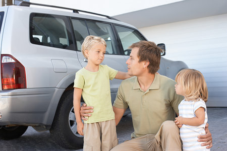 Father comforting his childrenの写真素材