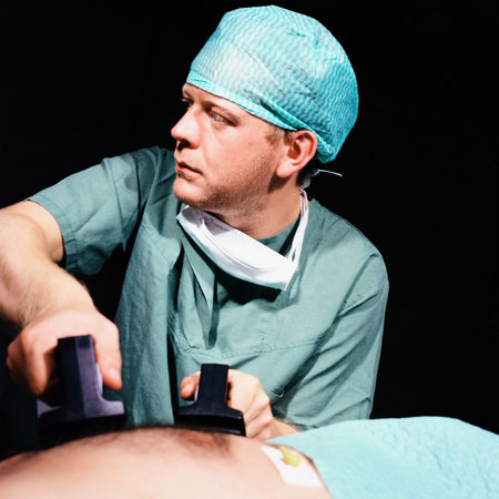 Nurse defibrillating patient