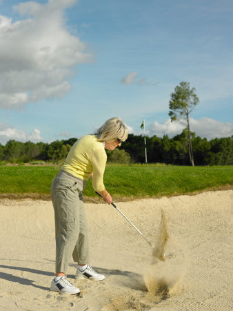 Woman playing golfの写真素材