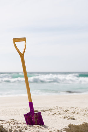 Spade in the sandの写真素材