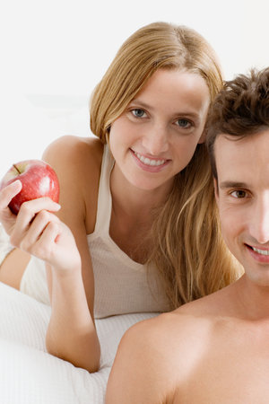 Man and woman with appleの写真素材