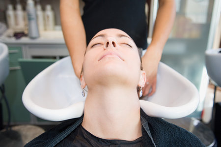 A woman having hair washedの写真素材