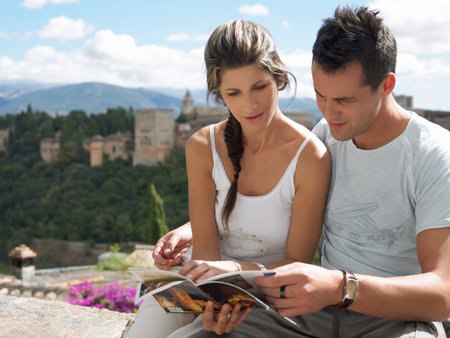 Couple looking at guidebookの写真素材