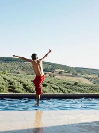 Boy jumping into swimming poolの写真素材