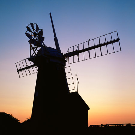 Silhouette of a windmill at sunset