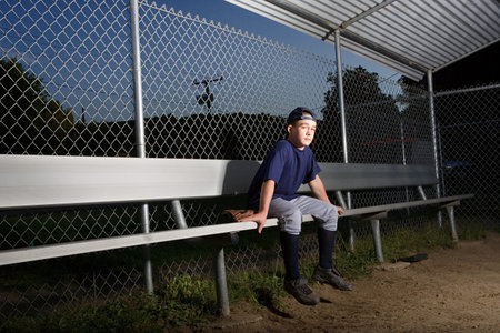 Teenage boy watching from the sidelinesの写真素材