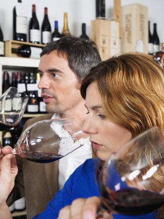 Two people tasting wineの写真素材