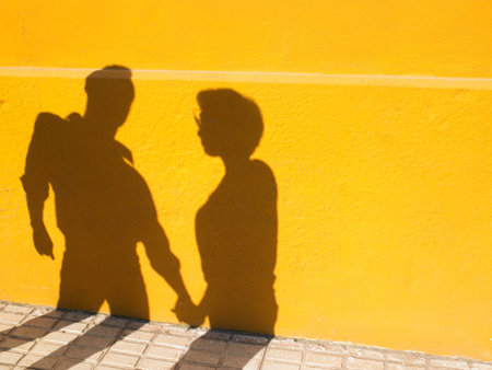 Shadows of a couple holding handsの写真素材