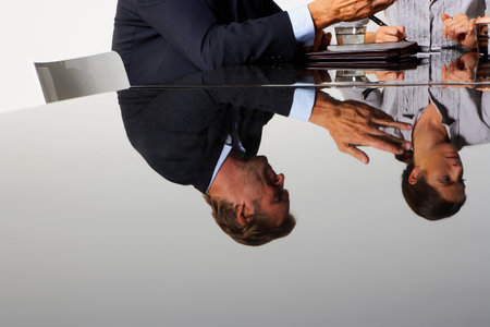 Two business people's reflectionの写真素材