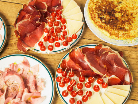 Plates of cooked meat and cheeseの写真素材