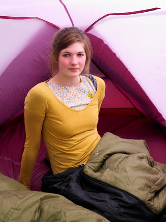 Girl sitting in sleeping bagの写真素材