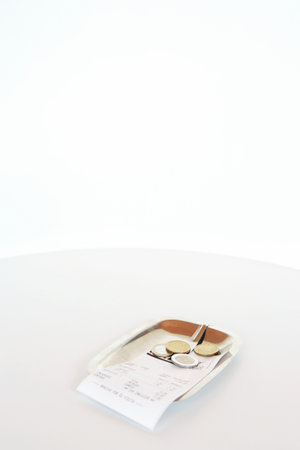 Bill with change in a saucer.