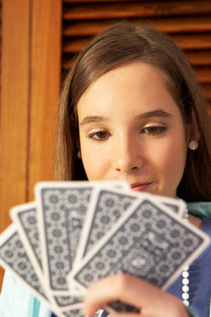 Girl holding playing cardの写真素材
