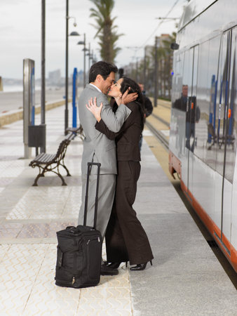 Couple wearing business suits kissingの写真素材
