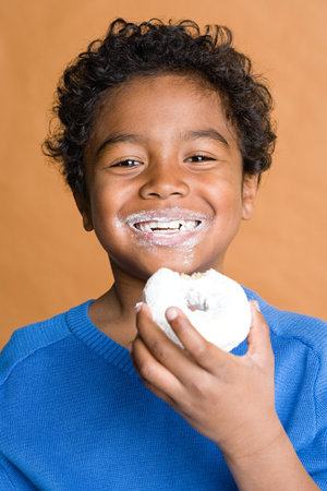 Boy eating a doughnutの写真素材