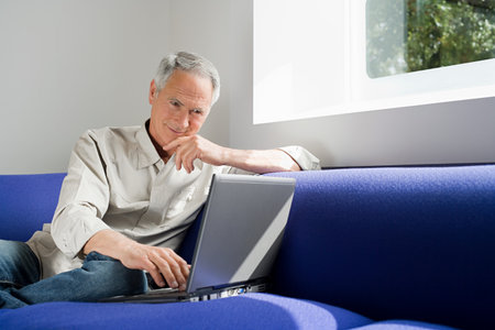 A senior man using a laptopの写真素材