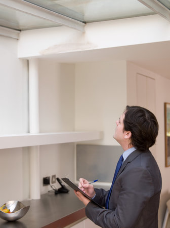 Surveyor writing on clipboardの写真素材