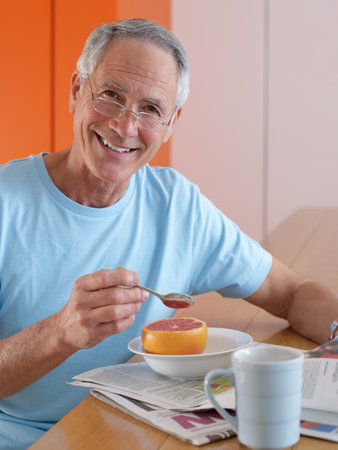 Portrait of a senior man having breakfastの写真素材