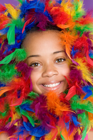 Girl with feathers around her faceの写真素材