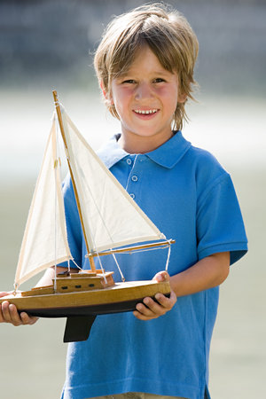 Boy with a toy boatの写真素材