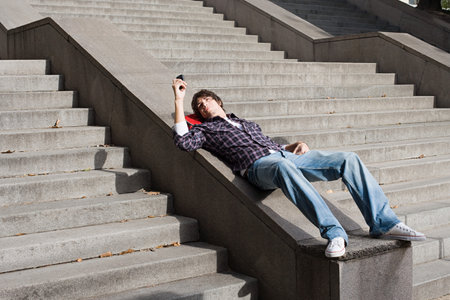 Teenage boy using a cellular telephoneの写真素材