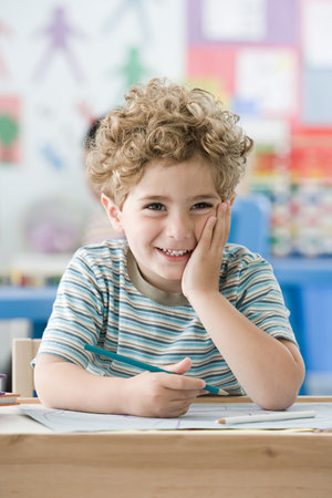 Boy with hand on his faceの写真素材