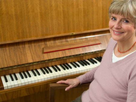 Senior woman sitting at piano