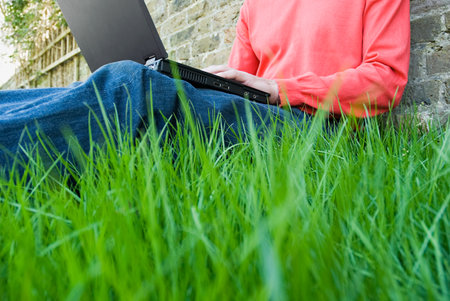 a man using laptop in gardenの写真素材