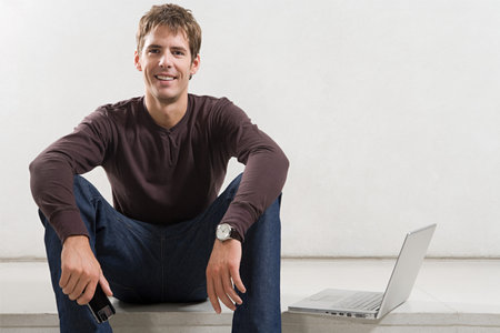 Portrait of a man with a laptopの写真素材