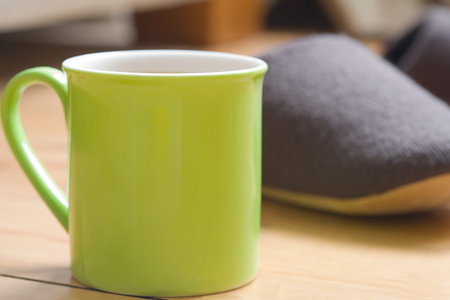 A green cup on a deskの写真素材