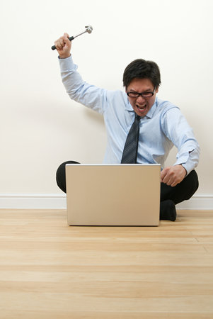 A businessman holding a hammerの写真素材